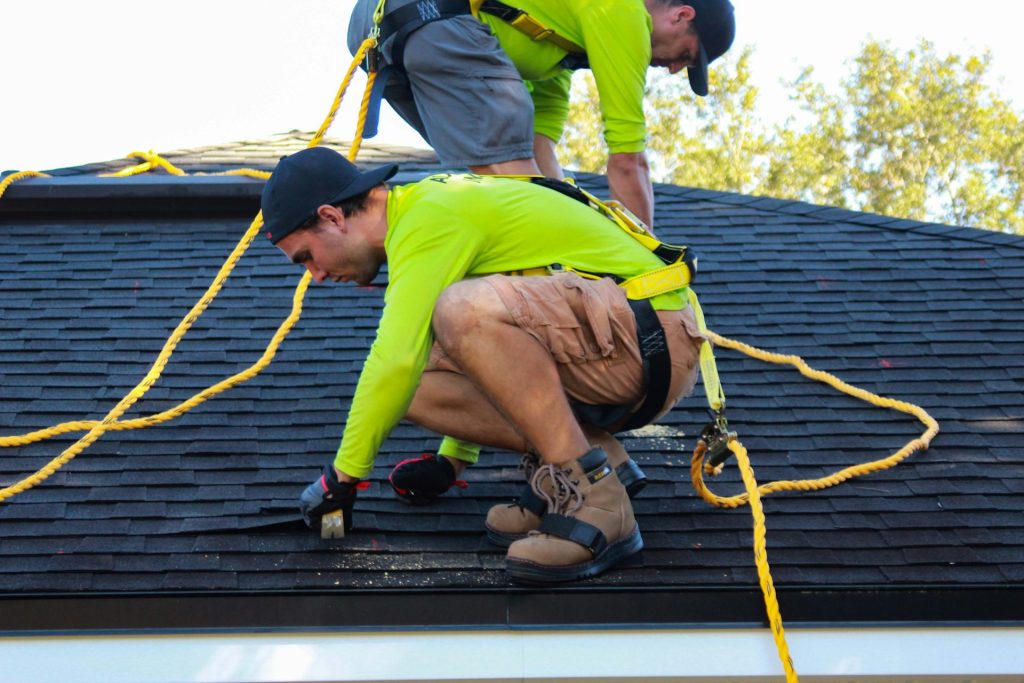 Roofing crew working on a shingle roof