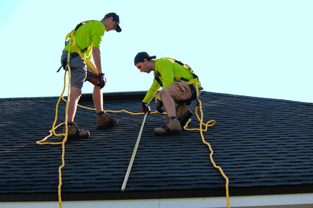 Roofing crew on an asphalt shingle roof